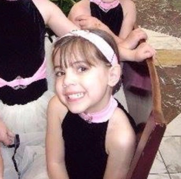 Paige at just four years old smiling before a big dance performance at Macy's store in Philadelphia. Photo credit to Carol VanAuken.