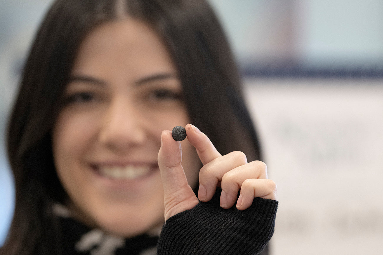 Paige holding her invention, the dissolving mascara tablet, with a big smile of pride. Photo by Jose F. Moreno
